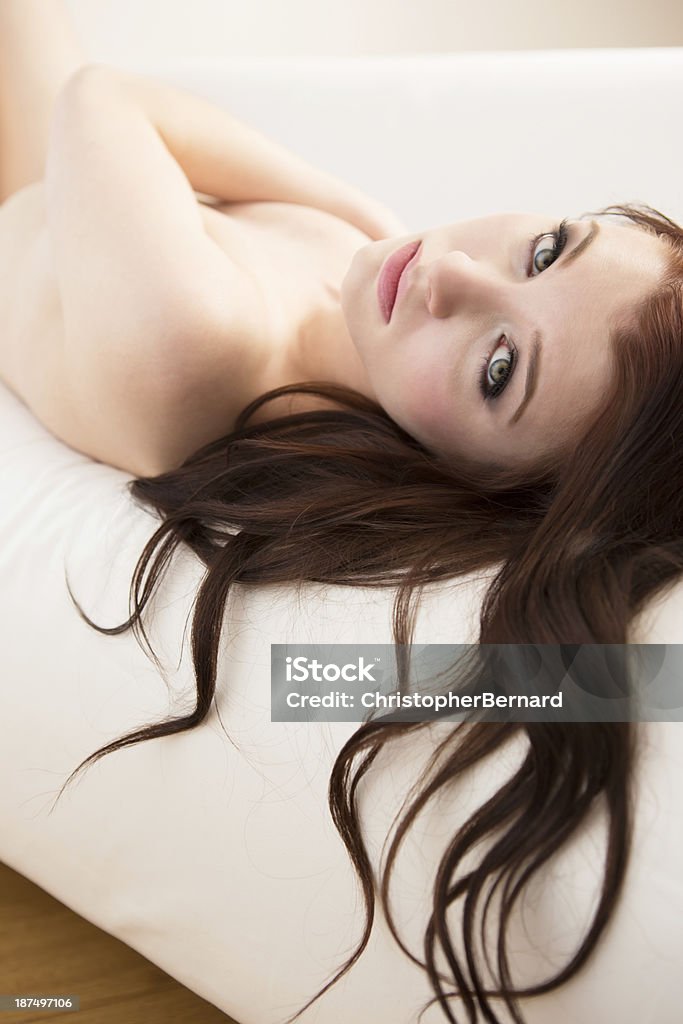 Beautiful woman laying on couch Topless woman laying on couch portrait 20-24 Years Stock Photo