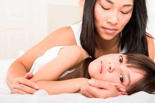 istock Mother and daughter laying in bed 187497167