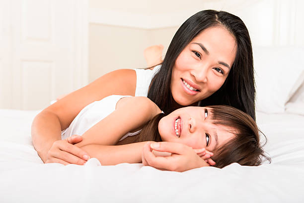 istock Mother and daughter laying in bed 187497470