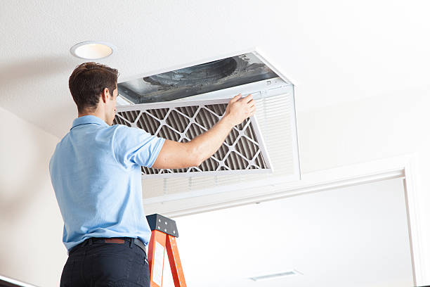 Removing Air Filter Man cleaning air ducts in home. filtration stock pictures, royalty-free photos & images