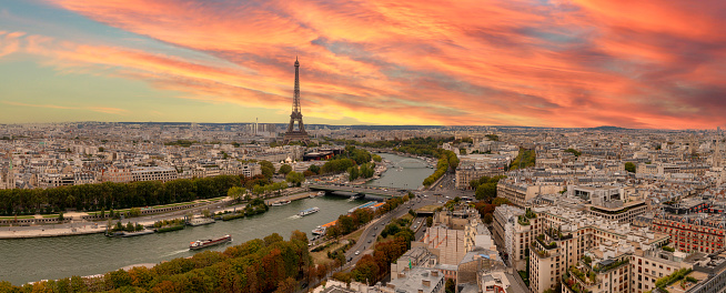 Aerial view of Paris city with Seine river and dramatic sky during sunset France