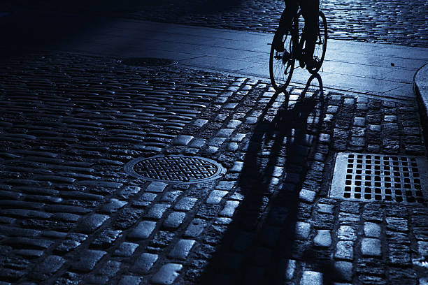 Japanese shopping street, woman on bicycle, monochrome, out of focus