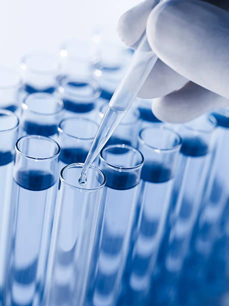istock Droplet Falling from Pipette into Test Tube 187499238