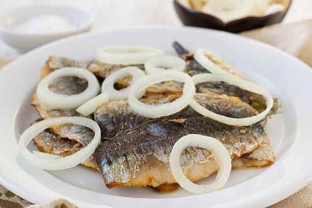 istock fried filet of sardines with onion on the plate 187500010