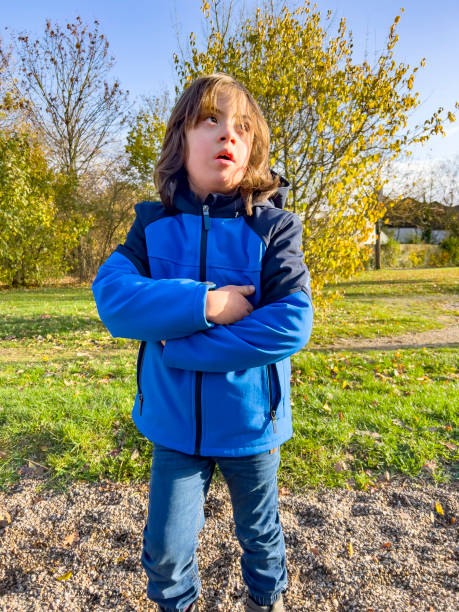 istock A boy with Down's syndrome posing with his arms crossed. 1875018032