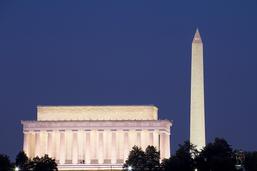 At night, lights illuminate the United States Capitol Building and the Washington Monument, Washington, D. C.