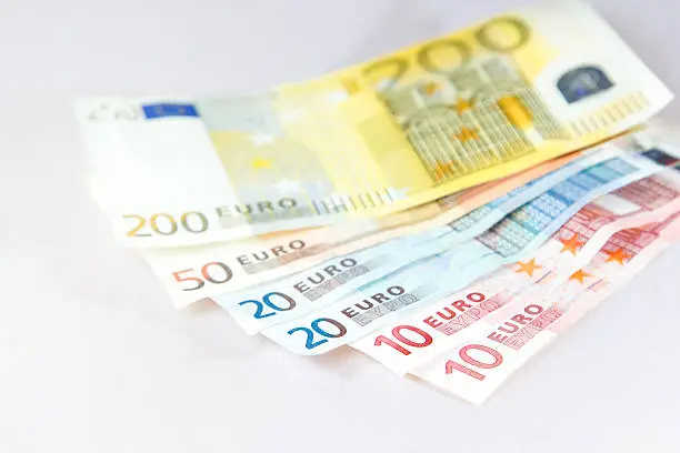 Euro notes lying on other notes with light white background
