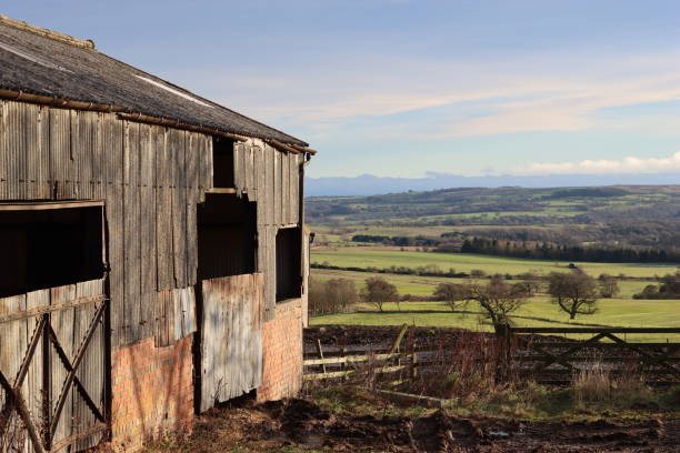 istock Old barn overlooking countryside in bright sunshine 1875026651