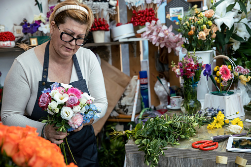 Woman florist working in her flower shop