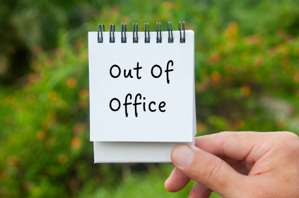 istock Hand holding notepad with Out Of Office text with nature background 1875042890