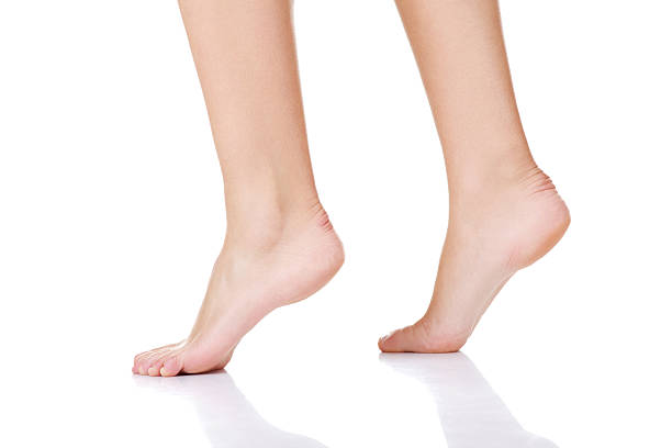 istock Female's bare feet and legs. 187504365