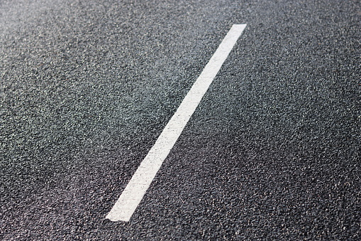 Centre white line marking on a tarmac road