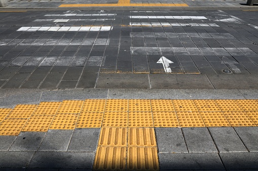 Tactile paving (tenji blocks) by the pedestrian crossing in Seoul, South Korea. Vision impaired disability infrastructure.