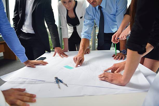 istock business people and engineers on meeting 187505960