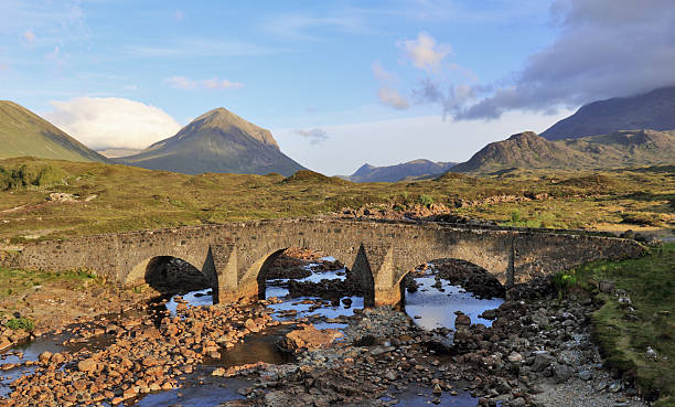 Ancient Bridge - Isle of Skye The Sligachan Bridge on the Isle of Skye, Scotland. With the Black Cuillin Mountains in the background. ford crossing stock pictures, royalty-free photos & images