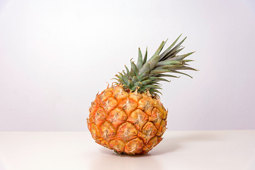 A perfectly ripe pineapple photographed on white background