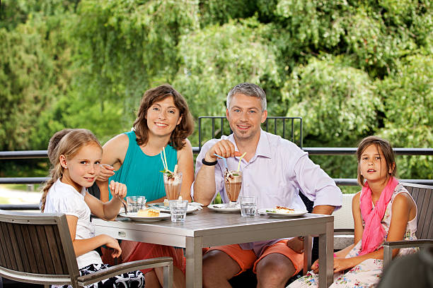 istock happy family having lunch in restaurant 187507363