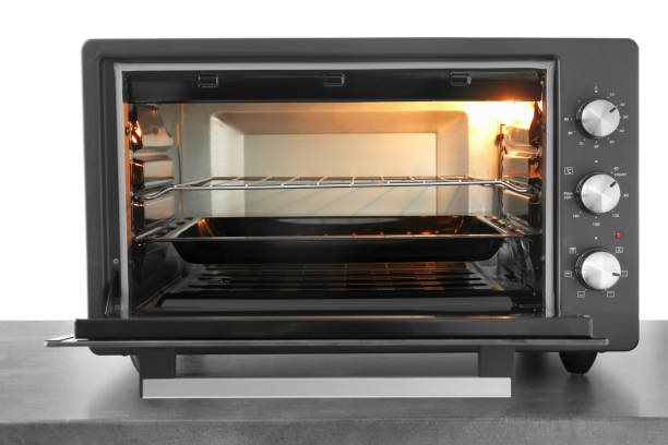istock One electric oven on grey table against white background 1875089803