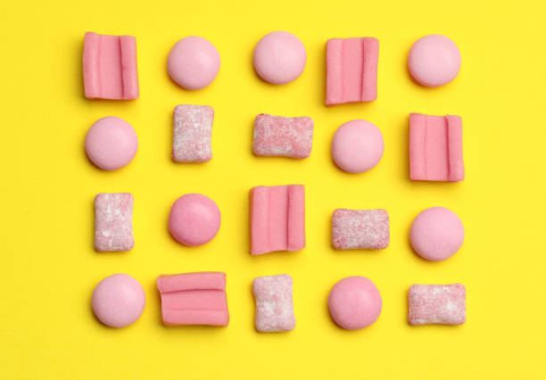 istock Pink bubble gums on yellow background, flat lay 1875090844