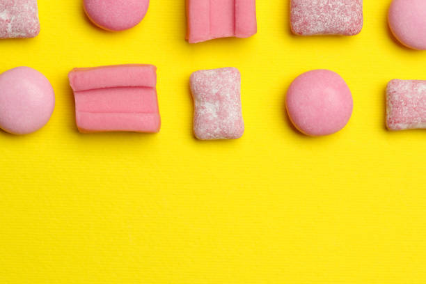 istock Pink bubble gums on yellow background, flat lay. Space for text 1875090846