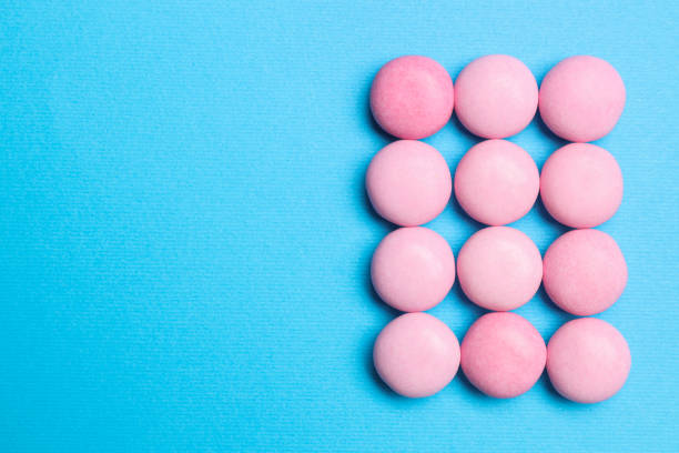 istock Pink bubble gums on blue background, flat lay. Space for text 1875091222