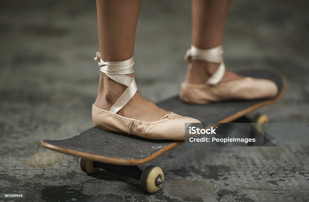 Tough on the inside A cropped image of a woman in ballet slippers on a skateboard Skateboard Stock Photo