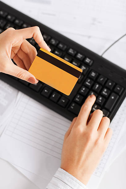 istock businesswoman with laptop using credit card 187510191