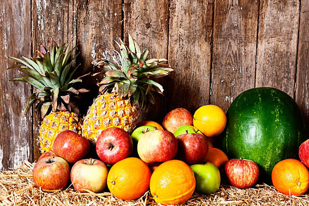 Healthy fresh fruit against weathered wooden background