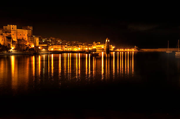 Mediterranean night panorama, Collioure, France The beautiful village and harbour at Collioure, Languedoc-Roussillon, France  collioure stock pictures, royalty-free photos & images