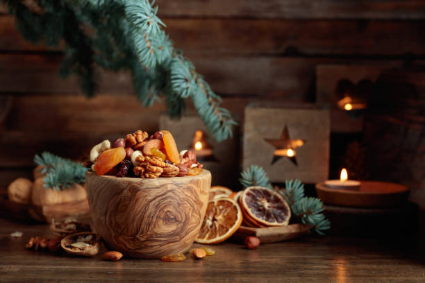 istock Dried fruits and assorted nuts on an old wooden table. 1875117851