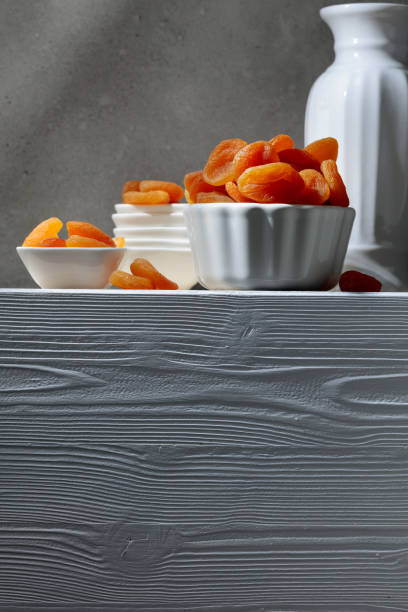 Dried apricots on a white wooden table.