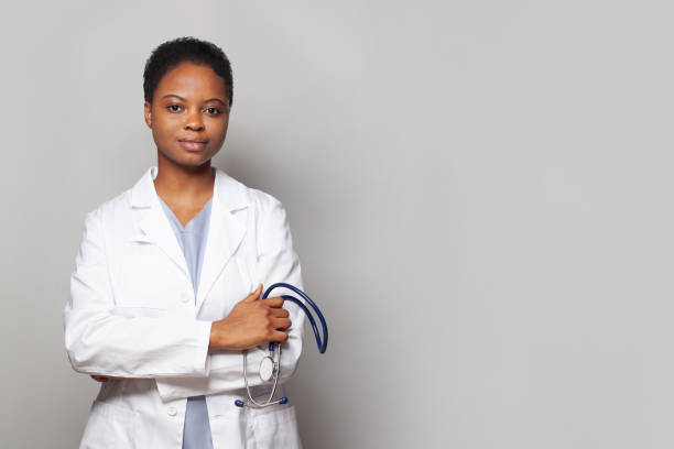 istock Confident physician woman medical worker with stethoscope standing on white background 1875120696