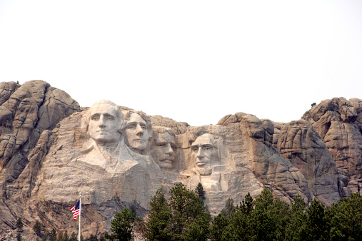 The four presidents of Mount Rushmore stare in various directions - George Washington, Thomas Jefferson, Theodore Roosevelt and Abraham Lincoln.  The National Memorial was created by over 400 workers carving, blasting and chiseling the honeycomb granite of the Black Hills between 1927 and 1941.