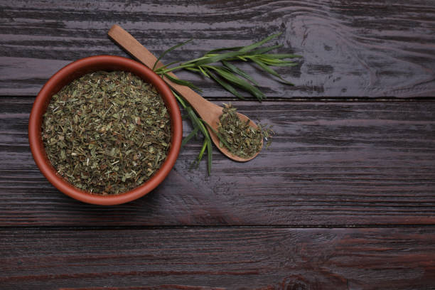istock Dry and fresh tarragon on wooden table, flat lay. Space for text 1875142939
