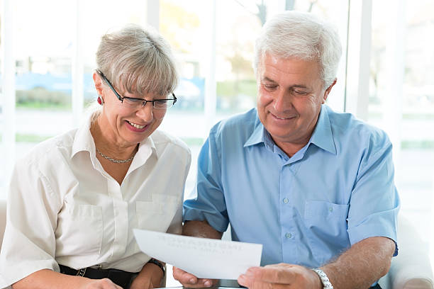 istock Senior couple read the form for life insurance 187514429