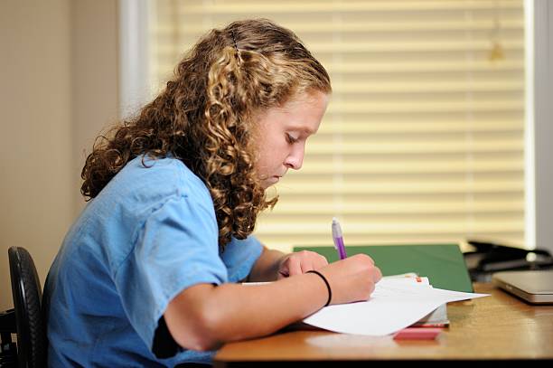 istock Teenage girl working homework 187514442