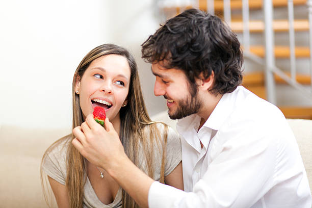 istock Young couple eating together 187515588