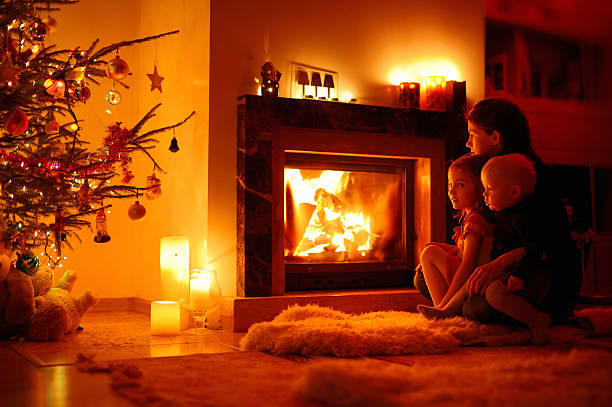 istock Young mother and her daughters by a fireplace 187515684