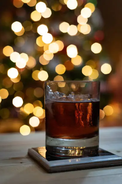 Drink in front of defocused Christmas tree
