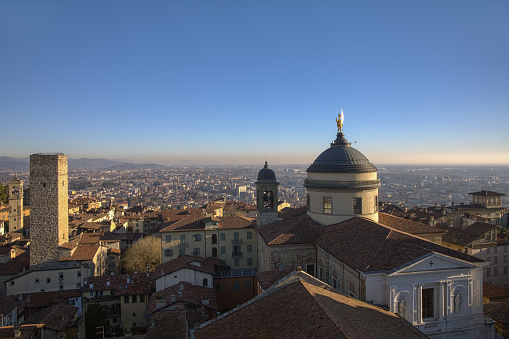 Bergamo. Historical Center, Upper City, Diomo and Gombito Tower (3) : a view from Civic Tower on Piazza Duomo - Bell tower of St. Pancratius church,  Gombito tower, Duomo bell tower, Duomo dome with golden statue of St. Alexander of Bergamo (by C. Broggi, 1851), Duomo of Bergamo.  Ph = 600 dpi.