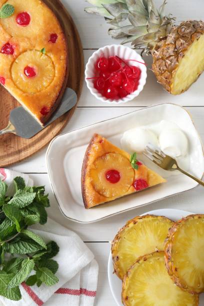 istock Delicious cut pineapple pie served with ice cream on white wooden table, flat lay 1875157237