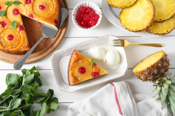istock Delicious cut pineapple pie served with ice cream on white wooden table, flat lay 1875157264