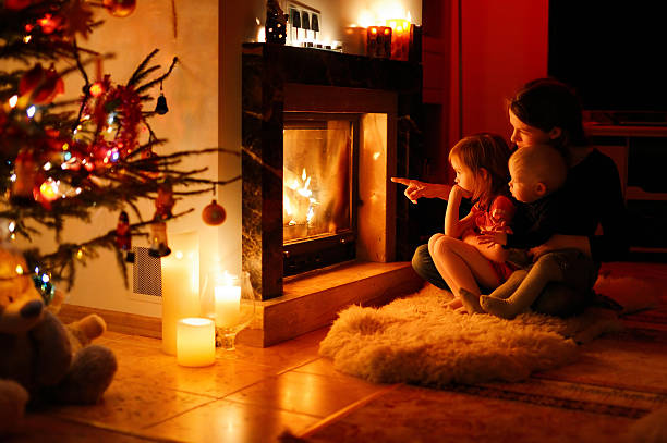 istock Young mother and her daughters by a fireplace 187515732