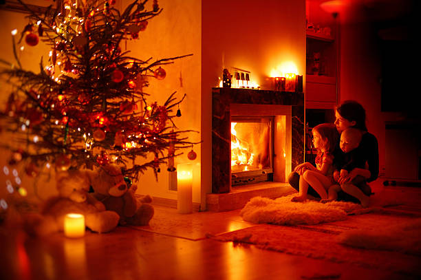 istock Young mother and her daughters by a fireplace 187515780