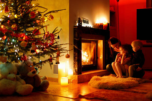istock Young mother and her daughters by a fireplace 187515787
