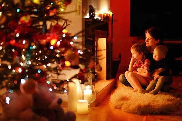 istock Young mother and her daughters by a fireplace 187515852