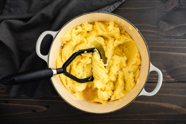 istock Mashing Boiled Yukon Gold Potatoes in a Large Pot 1875177864