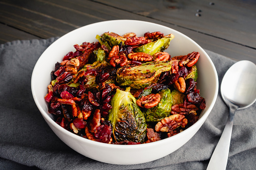 Vegetable side dish made with baby cabbages, toasted pecan halves, and dried cranberries