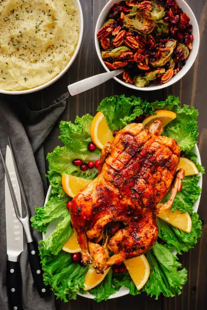 Christmas dinner with glazed duck on a garnished platter with side dishes