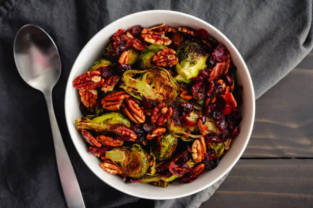 Vegetable side dish made with baby cabbages, toasted pecan halves, and dried cranberries